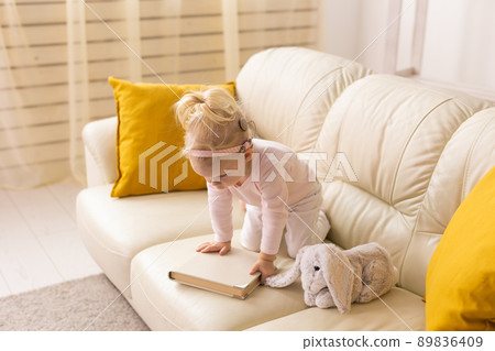 Cochlear implant for baby. Deaf child with hearing aid at home - diversity concept 89836409