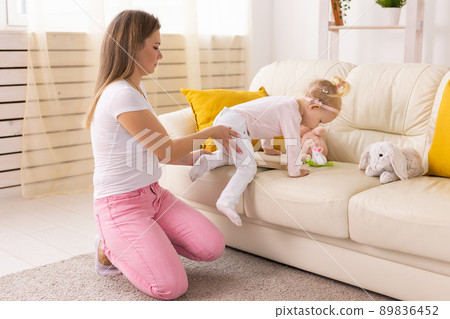 Happy child girl with cochlear implant having fun with her mother - hearing aid for deaf and innovative health technology and diversity concept 89836452