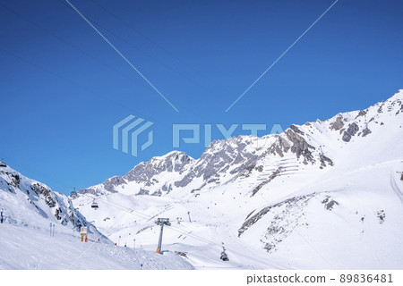 Chairlift on snow covered mountain against clear blue sky Chairlift on snow covered mountain against clear blue sky 89836481