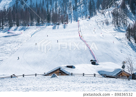 Snow covered house against trees on mountain during winter in alps Snow covered house against trees on mountain during winter in alps 89836532