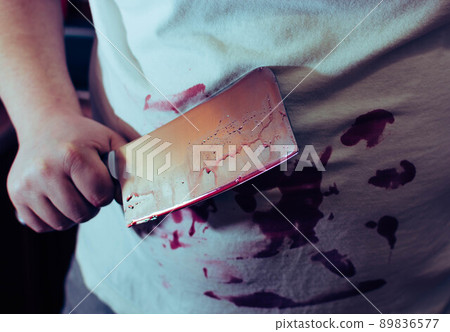 An ax knife in blood, in the hands of a man, clothes in blood 89836577
