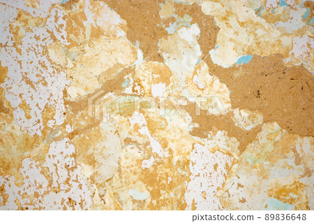 Background of cracked clay wall covered with crumbling lime and old paint. 89836648