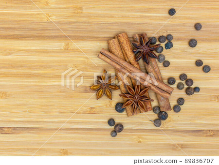 Cooking background, anise with cinnamon sticks and fragrant pepper on the kitchen board Cooking background, anise with cinnamon sticks and fragrant pepper on the kitchen board 89836707