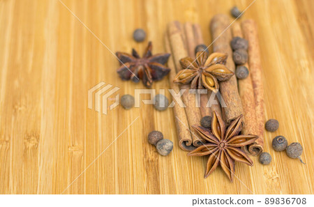 Cooking background, anise with cinnamon sticks and fragrant pepper on the kitchen board Cooking background, anise with cinnamon sticks and fragrant pepper on the kitchen board 89836708