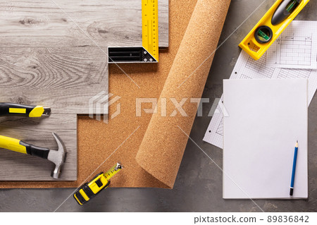 Wood laminate and tools on floor background texture. Wooden laminate top view Wood laminate and tools on floor background texture. Wooden laminate top view 89836842