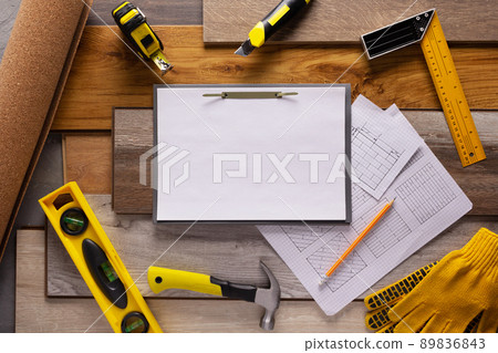 Wood laminate and tools on floor background texture. Wooden laminate top view Wood laminate and tools on floor background texture. Wooden laminate top view 89836843