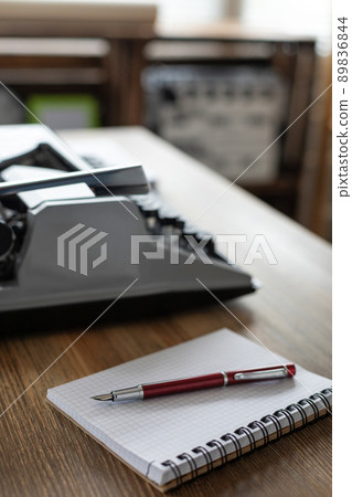 Notebook and vintage old typewriter on desk table Notebook and vintage old typewriter on desk table 89836844