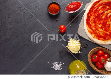 Pizza and sauce homemade cooking with ingredients on table. Dough pizza at tabletop 89836852