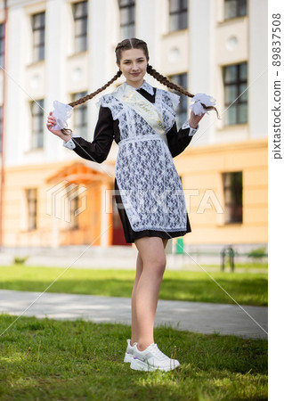 Happy Russian schoolgirl on the last day of school. 89837508