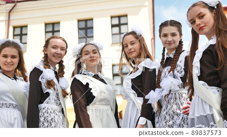 Smiling female graduates pose on the last day of school life. Smiling female graduates pose on the last day of school life. 89837573