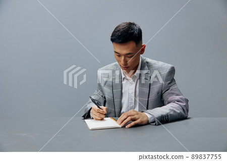 businessmen writes in a notebook sits on the table dissatisfaction official isolated background 89837755