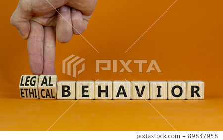 Legal or ethical behavior symbol. Businessman turns cubes, changes words ethical behavior to legal behavior. Beautiful orange background, copy space. Psychology, legal or ethical behavior concept. 89837958