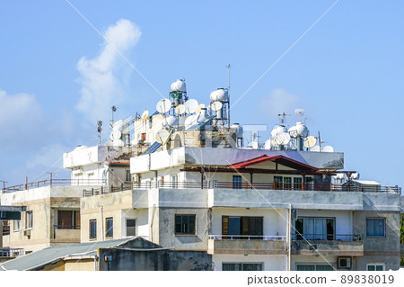 Traditional Cypriot urban landscape with white houses, satellite dishes and water heating tanks 89838019