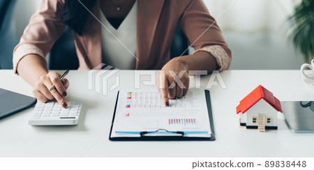 Close up of Business woman pointing and signing agreement for buying house. Bank manager concept. 89838448