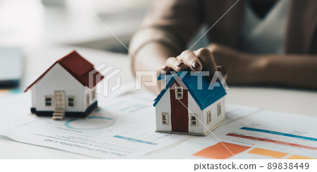 Close up of Business woman choosing house after signing agreement for buying house. Bank manager concept. 89838449