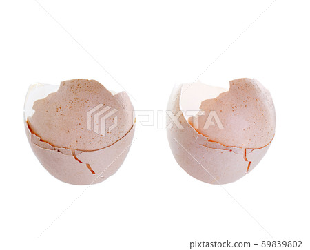 broken eggs with a cracked shell, part of a cracked brown bird's egg isolated on a white background. 89839802