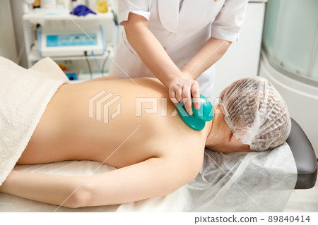 Vacuum massage. Vacuum cups of medical cupping therapy on woman back, close up, chinese medicine. Vacuum massage. Vacuum cups of medical cupping therapy on woman back, close up, chinese medicine. 89840414