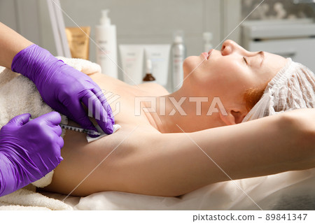 Armpit anti hyperhidrosis treatment. Cosmetic injection procedure. Clinic cosmetology sweat therapy. Beauty young woman. Girl skin care. Armpit anti hyperhidrosis treatment. Cosmetic injection procedure. Clinic cosmetology sweat therapy. Beauty young woman. Girl skin care. 89841347