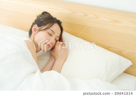 A woman sleeping in bed A woman sleeping in bed 89841814