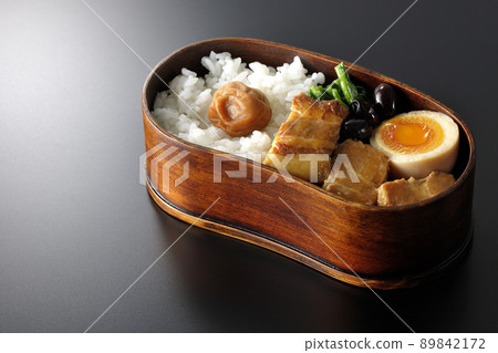 Kakuni bento with magewappa, black beans, spinach, and soft-boiled eggs taken on a black background 89842172