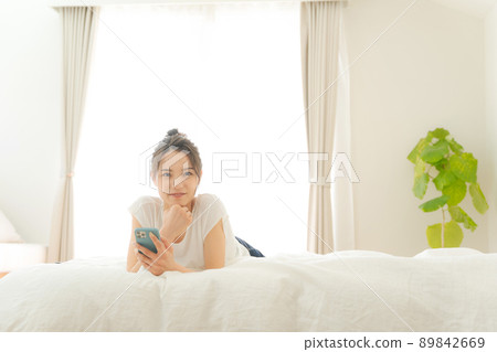 A woman relaxing in bed 89842669
