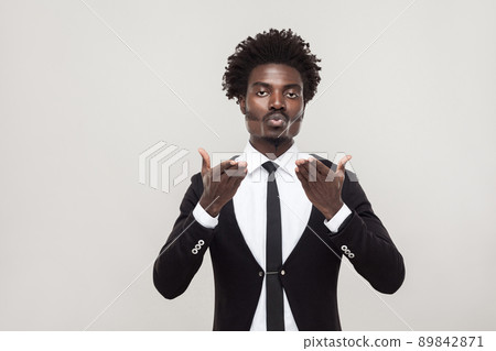 African man send air kissing at camera with love . Studio shot, gray background African man send air kissing at camera with love . Studio shot, gray background 89842871