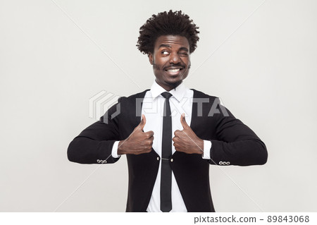 Happiness businessman looking at camera and thumbs up. Studio shot, gray background 89843068