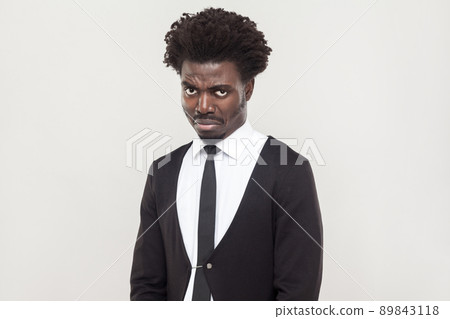 Dramatic afro man cry and looking at camera. Studio shot, gray background 89843118