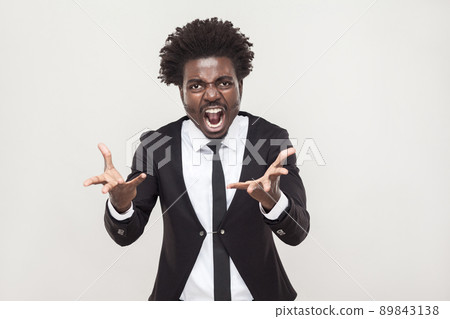 Roar! Angry man shouting at camera. Wild and crazy. Studio shot 89843138
