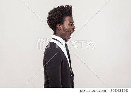 Profile view angry african man. Studio shot Profile view angry african man. Studio shot 89843198