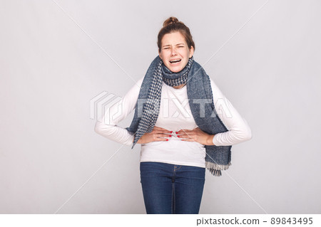 Periods, monthly, monthlies concept. Young woman have a stomach. Studio shot 89843495