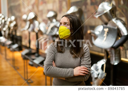 Interested brunette in mask visiting exhibition of historical museum 89843785