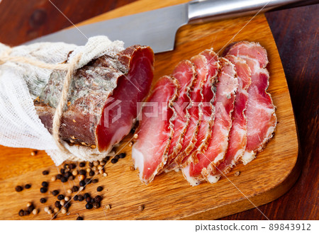 Sliced cured sirloin pork on wooden cuting board 89843912