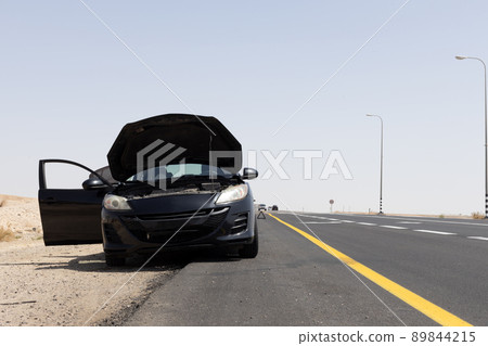 black car with open hood on the side of the road black car with open hood on the side of the road 89844215
