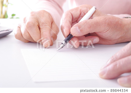 Senior writing sentences on stationery Senior writing sentences on stationery 89844334