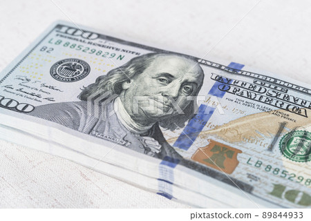 A lot of dollar bills on a white background 89844933