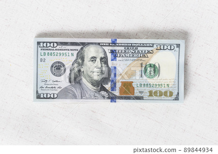 A lot of dollar bills on a white background 89844934