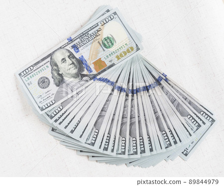 A lot of dollar bills on a white background 89844979