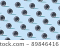 Pattern made with silver bitcoins and sharp shadows on pastel blue background. Creative cryptocurrency blockchain concept. Stock Market, digital gold money and stock business. Sunlight 89846416
