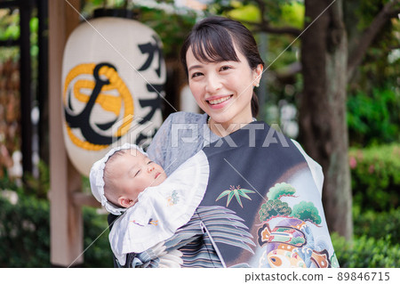 Mom hugging her baby outside 89846715