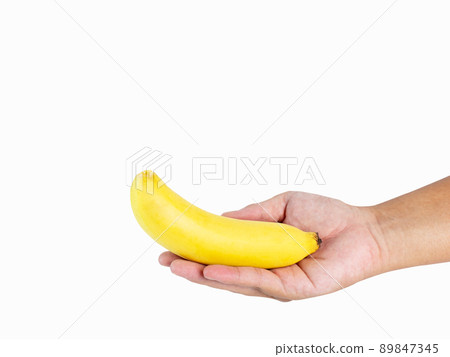Hand holding 1 banana, golden yellow, ripe, ready to eat, rich in nutrients Great effect shot in a studio on a white background with clipping paths and copy space isolated. Hand holding 1 banana, golden yellow, ripe, ready to eat, rich in nutrients Great effect shot in a studio on a white background with clipping paths and copy space isolated. 89847345