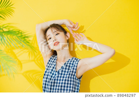 Summer woman yellow background 89848297