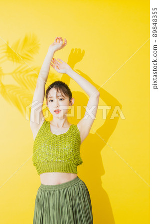 Summer woman yellow background 89848355