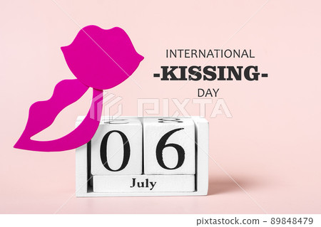 Red lips, calendar isolated on pink background 06 July - International Kissing Day concept Greeting holiday card. 89848479
