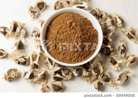Brown seeds and moringa powder. Close-up, top view. 89849008