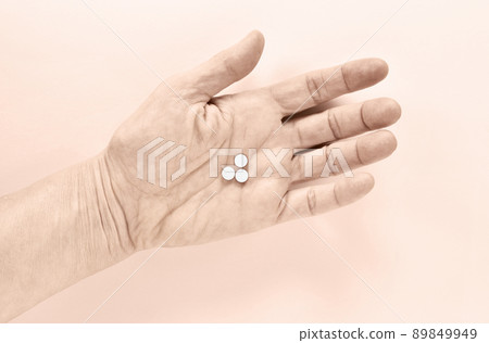 Medicine pills on female hand 89849949