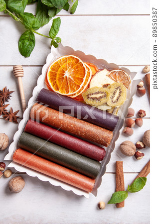 Fruit pastille of different flavors and fruit chips or dried fruit slices in a gift box Fruit pastille of different flavors and fruit chips or dried fruit slices in a gift box 89850387