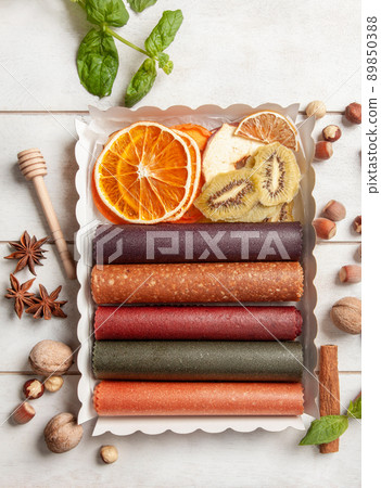 Fruit pastille of different flavors and fruit chips or dried fruit slices in a gift box Fruit pastille of different flavors and fruit chips or dried fruit slices in a gift box 89850388