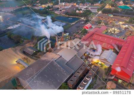 Aerial view of factory industry with smoke and toxic air from chimney in energy and pollution environment concept with city town landscape background. 89851178