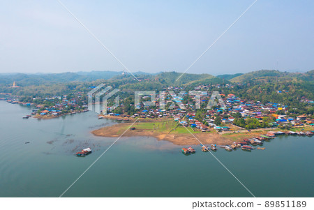 Aerial top view of residential local floating houses in Mon village, nature trees with lake or river, Kanchanaburi, Thailand in urban city town in Asia, buildings. 89851189